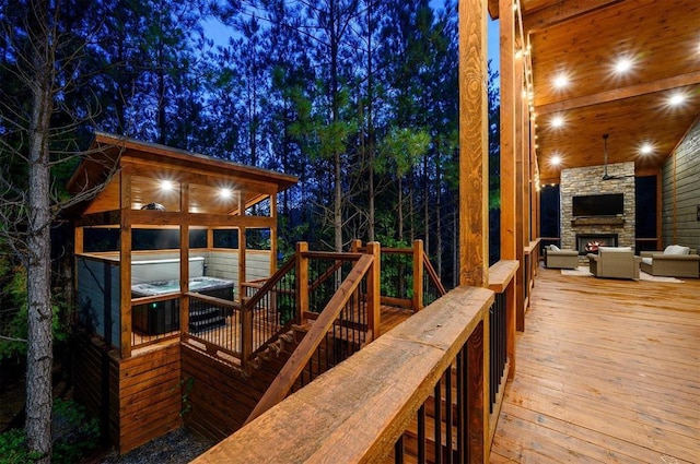 wooden deck featuring an outdoor living space with a fireplace