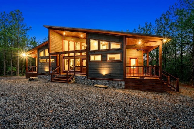 rear view of property with covered porch