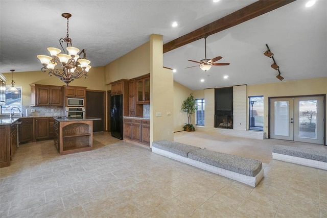 kitchen with decorative backsplash, stainless steel appliances, pendant lighting, beamed ceiling, and a fireplace