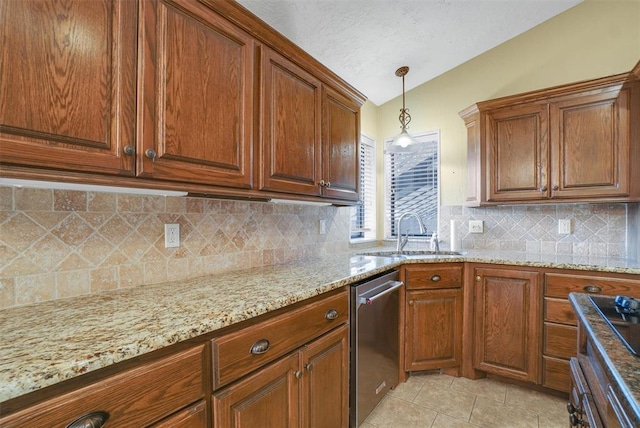 kitchen with light stone countertops, sink, stainless steel dishwasher, decorative light fixtures, and light tile patterned floors