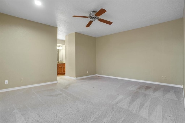 carpeted empty room with a textured ceiling and ceiling fan