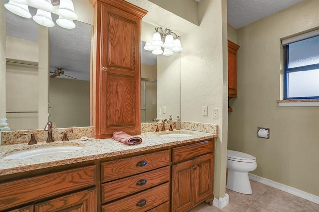 bathroom featuring vanity, tile patterned floors, ceiling fan with notable chandelier, toilet, and a textured ceiling