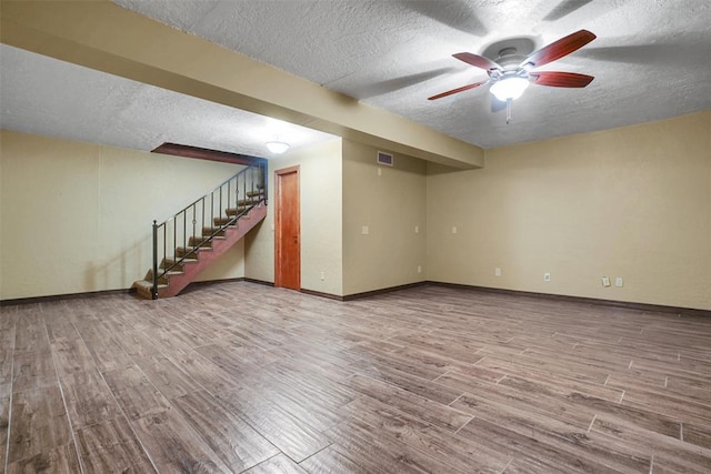 interior space featuring ceiling fan, a textured ceiling, and hardwood / wood-style flooring