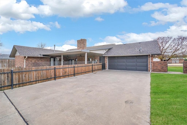 single story home featuring a garage and a front lawn