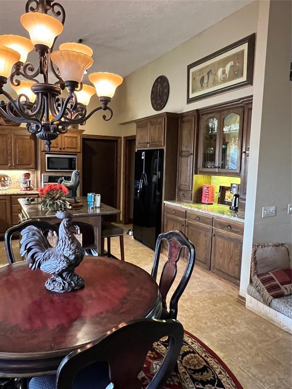 tiled dining room featuring a chandelier