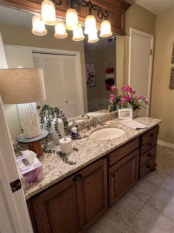 bathroom with tile patterned flooring and vanity