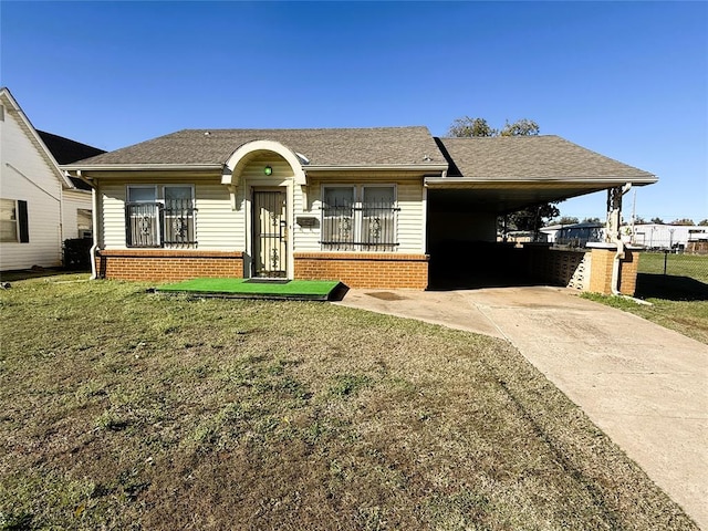 ranch-style home featuring a carport and a front lawn