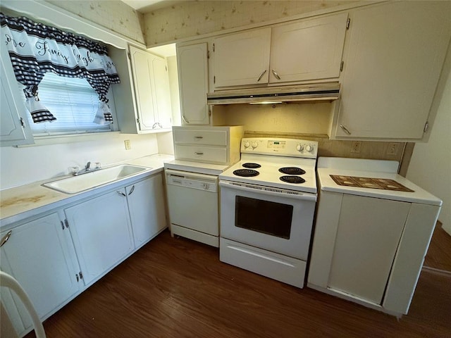 kitchen with dark hardwood / wood-style flooring, white cabinets, white appliances, and sink