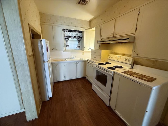 kitchen with white cabinets, white appliances, dark wood-type flooring, and sink