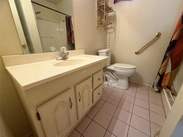 bathroom with toilet, vanity, tile patterned floors, and walk in shower