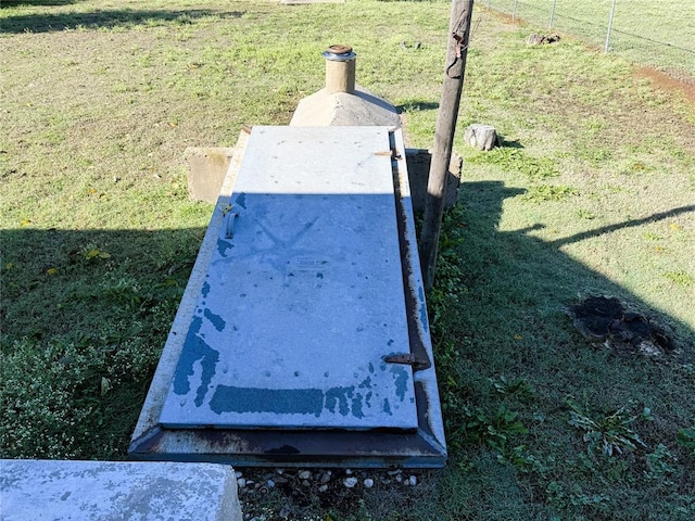 entry to storm shelter featuring a lawn