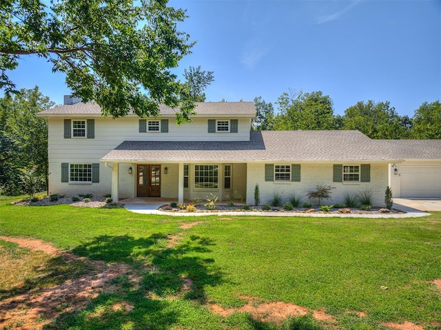 view of front of property featuring covered porch, a garage, and a front lawn