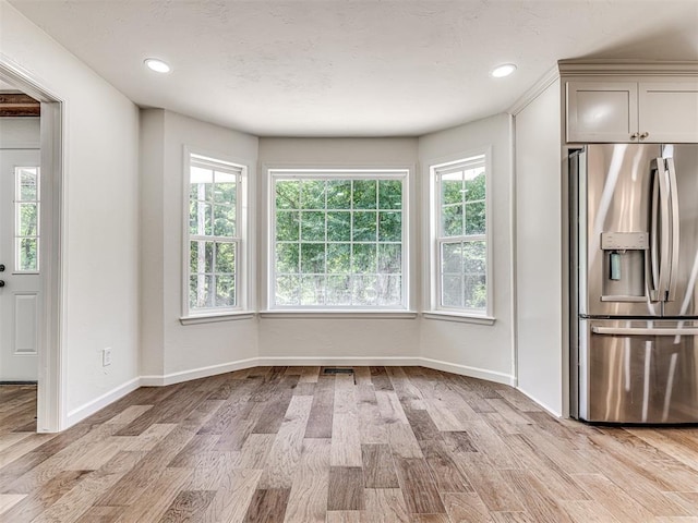 unfurnished dining area featuring light hardwood / wood-style flooring