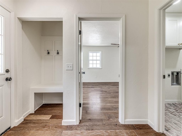 mudroom with hardwood / wood-style floors and a textured ceiling