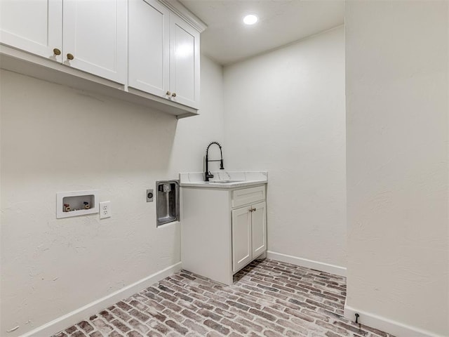 laundry room with hookup for an electric dryer, hookup for a washing machine, cabinets, and sink