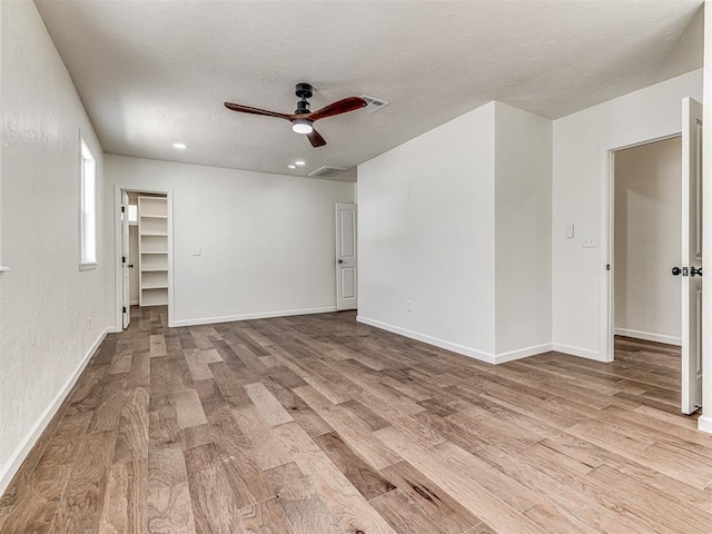 empty room featuring ceiling fan and light hardwood / wood-style floors