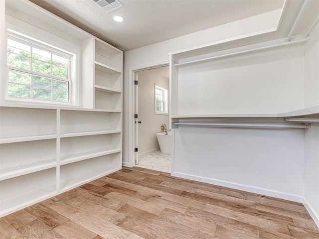 walk in closet featuring light wood-type flooring