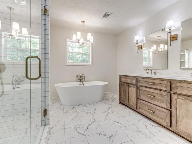 bathroom featuring vanity, independent shower and bath, and a notable chandelier