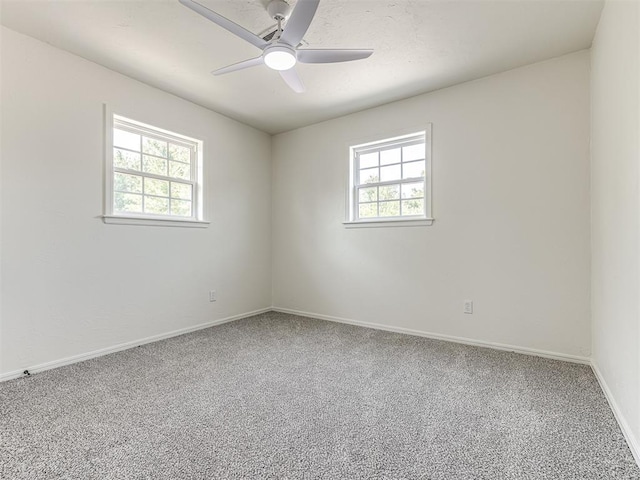 unfurnished room with plenty of natural light, ceiling fan, and carpet floors