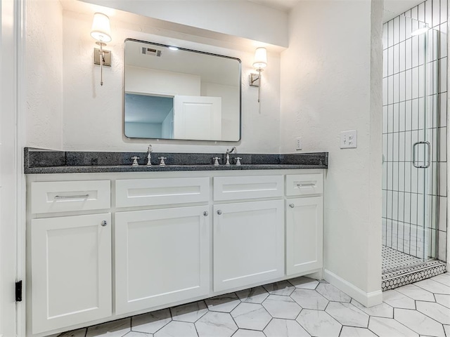 bathroom with tile patterned floors, vanity, and a shower with shower door