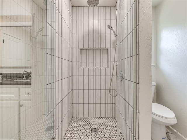 bathroom featuring an enclosed shower and toilet