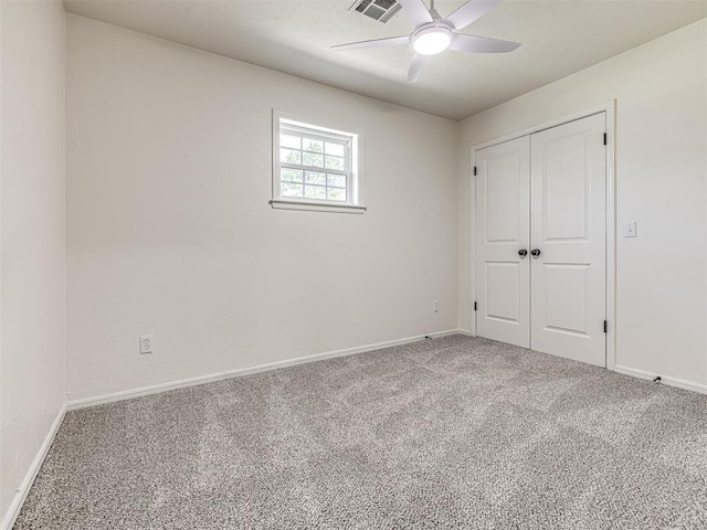 unfurnished bedroom with carpet flooring, ceiling fan, and a closet