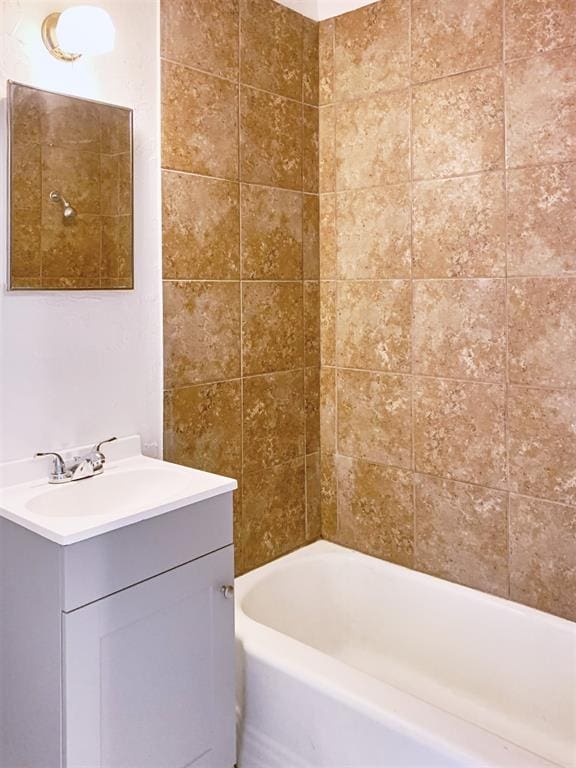 bathroom with vanity and tiled shower / bath combo