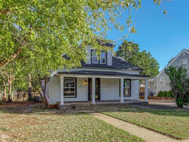 bungalow-style home featuring covered porch and a front yard