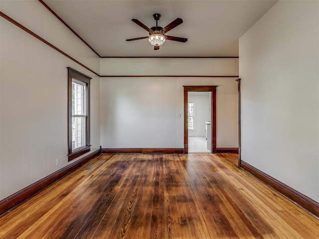 spare room with hardwood / wood-style floors and ceiling fan