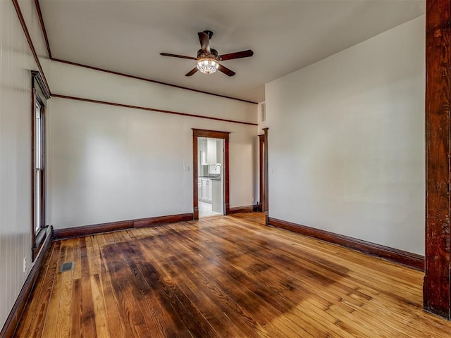 spare room featuring wood-type flooring and ceiling fan