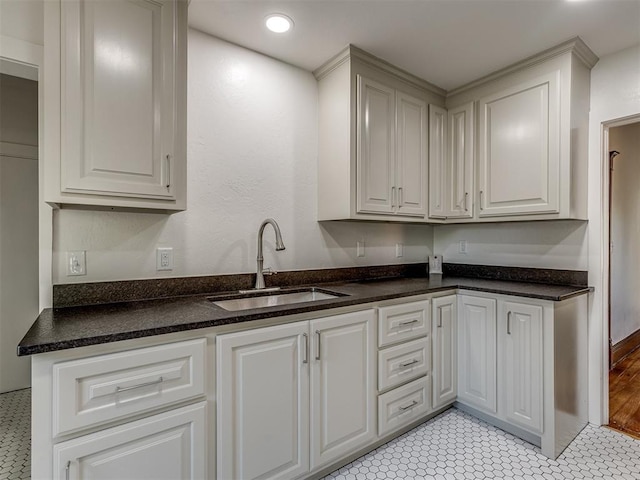 309 S 6th St, Kingfisher, OK 73750 - kitchen featuring a sink, white cabinets, recessed lighting, and dark stone countertops