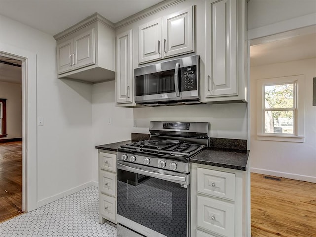 309 S 6th St, Kingfisher, OK 73750 - kitchen with appliances with stainless steel finishes, dark countertops, and baseboards