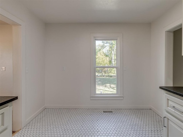 unfurnished dining area with light tile patterned floors