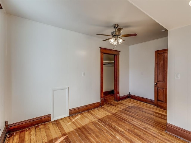 unfurnished bedroom featuring a closet, light hardwood / wood-style flooring, and ceiling fan