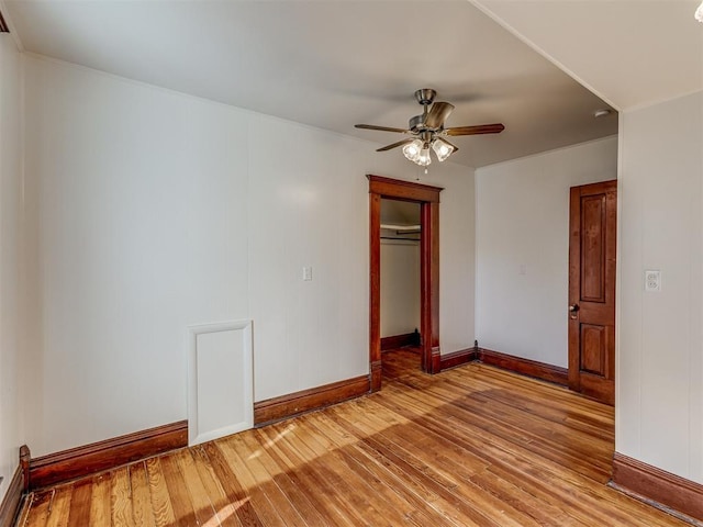 309 S 6th St, Kingfisher, OK 73750 - unfurnished bedroom featuring light wood finished floors, baseboards, a closet, a ceiling fan, and ornamental molding