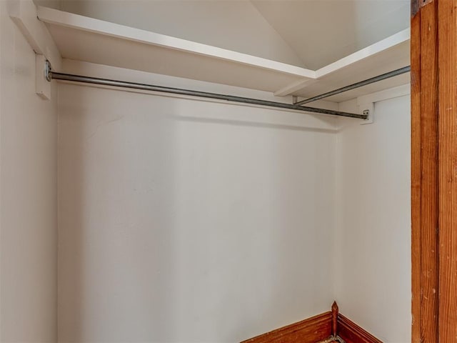 walk in closet with vaulted ceiling