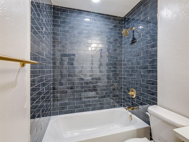 bathroom featuring toilet and tiled shower / bath