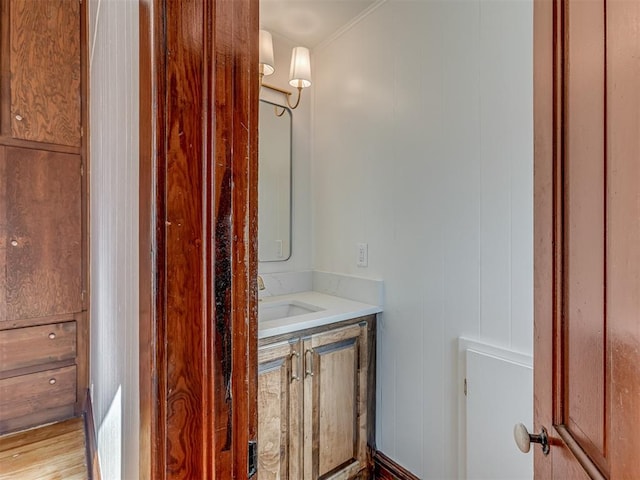 bathroom featuring wood-type flooring, vanity, and wooden walls