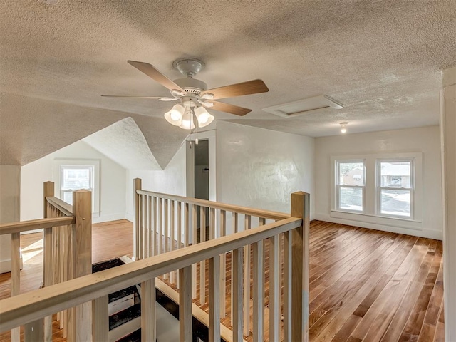 309 S 6th St, Kingfisher, OK 73750 - hall featuring a textured ceiling, an upstairs landing, wood finished floors, and healthy amount of natural light