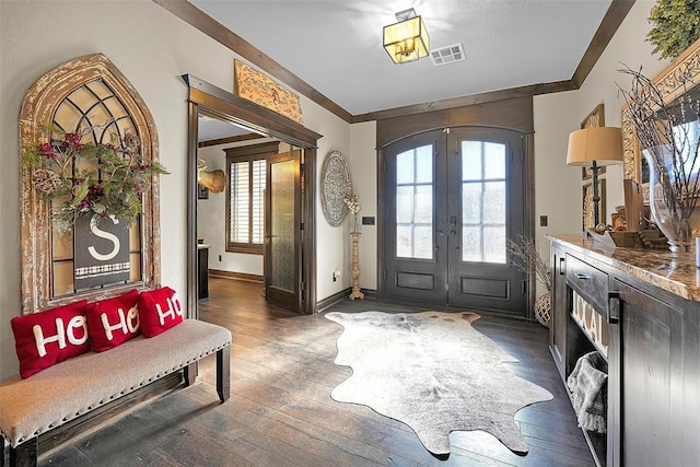 entryway with crown molding, french doors, dark wood-type flooring, and plenty of natural light