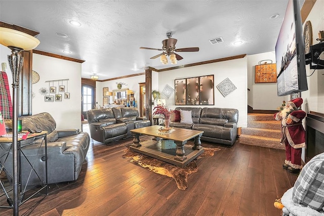 living room with dark hardwood / wood-style floors, ceiling fan, crown molding, and a textured ceiling