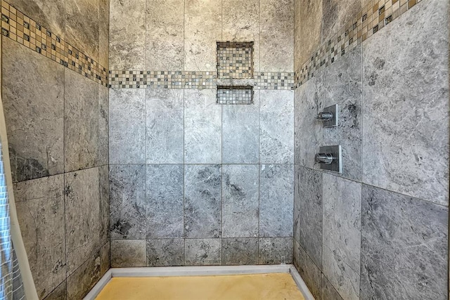 bathroom with a tile shower