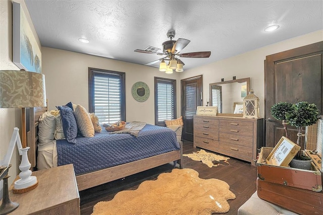 bedroom with a textured ceiling and ceiling fan