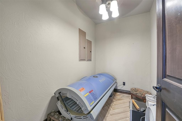 interior space with ceiling fan, parquet floors, and electric panel