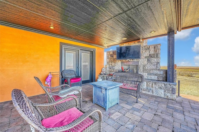 view of patio with an outdoor stone fireplace