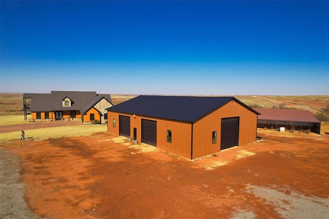 view of front facade featuring an outbuilding and a garage