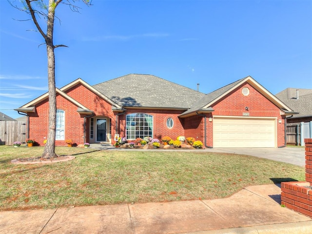 view of front of house featuring a front yard and a garage