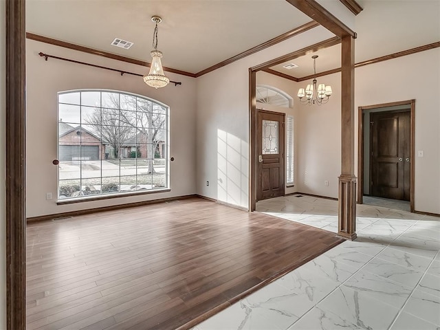 entrance foyer with light hardwood / wood-style floors, ornamental molding, and a notable chandelier