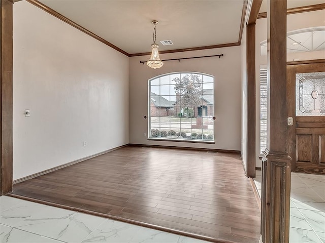 entrance foyer with wood-type flooring, crown molding, and ornate columns