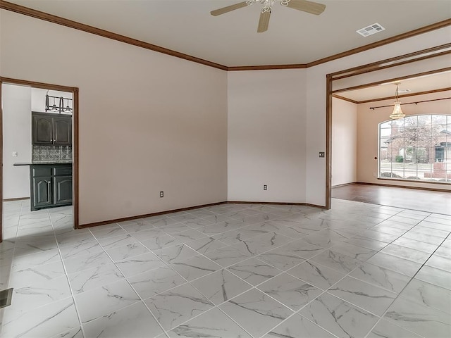 unfurnished room with ceiling fan and ornamental molding